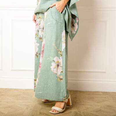 The sage green Bouquet Print Linen Trousers with a wide stretchy elasticated waistband for extra comfort 